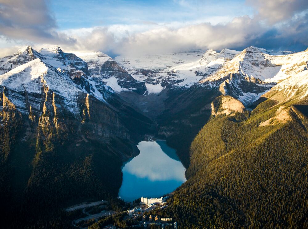 An aerial view of Lake Louise in Banff National Park at sunrise.