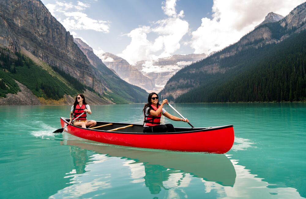 Two people canoeing on Lake Louise, one of the best things to do in June in Banff National Park