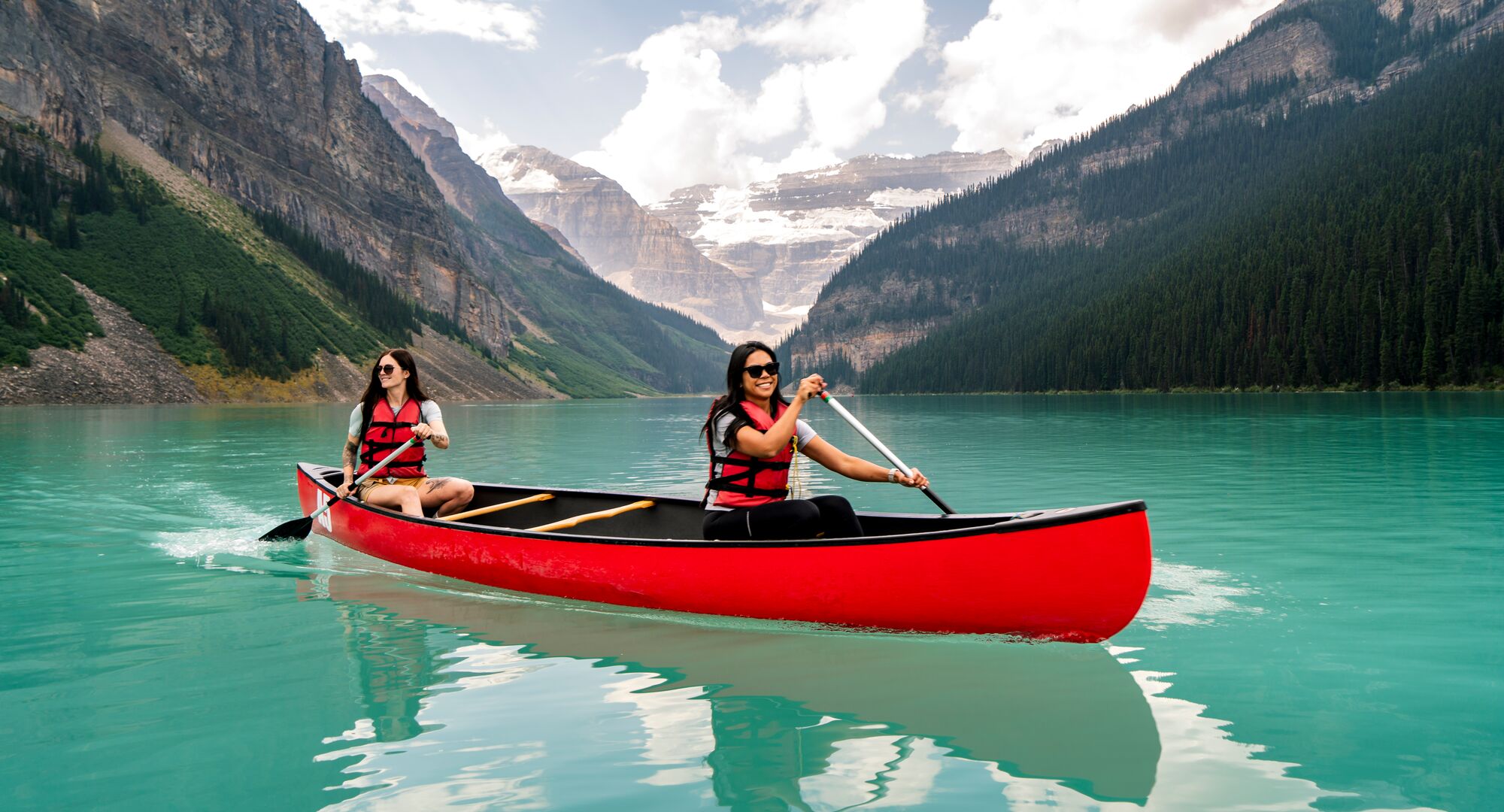 Two people canoeing on Lake Louise, one of the best things to do in June in Banff National Park