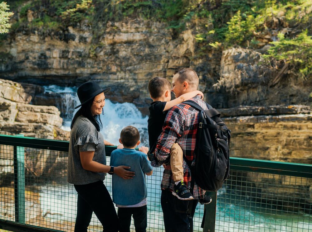 A family of four hiking in Johnston Canyon in Banff National Park