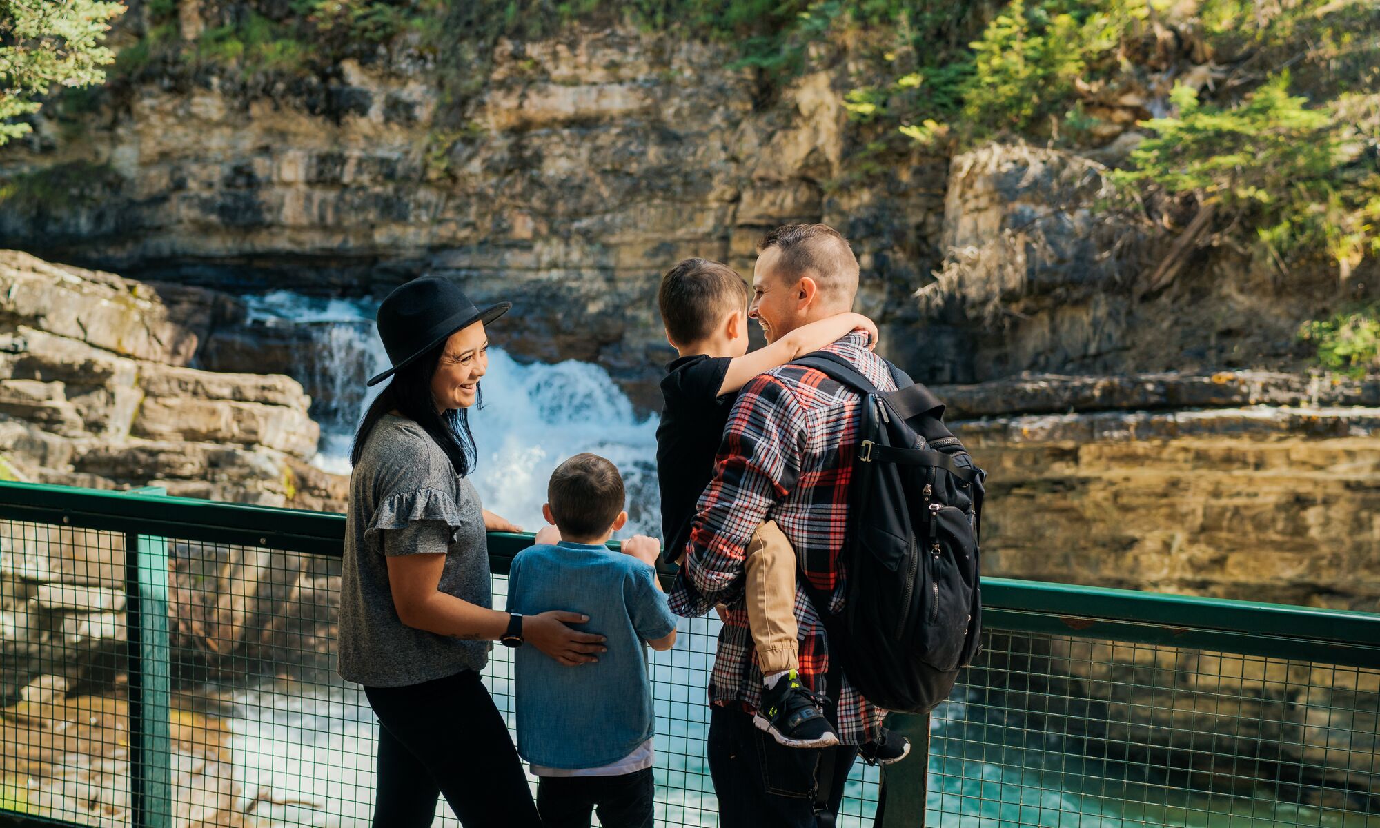 A family of four hiking in Johnston Canyon in Banff National Park