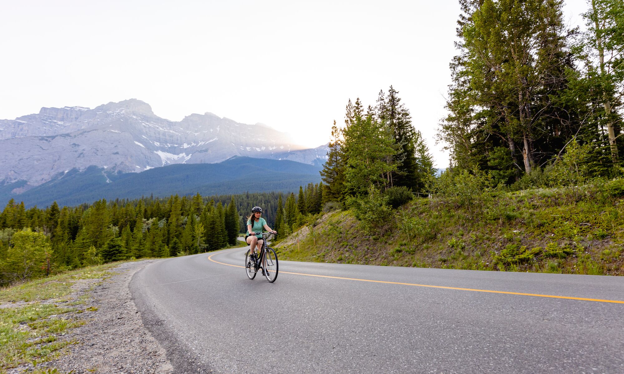 A person bikes on the Minnewanka Loop in Banff National Park.