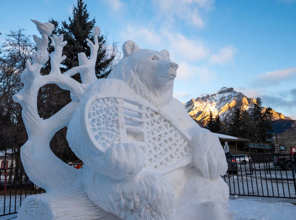 A snow sculpture of a bear with a snowshoe at the SnowDays Festival in Banff National Park