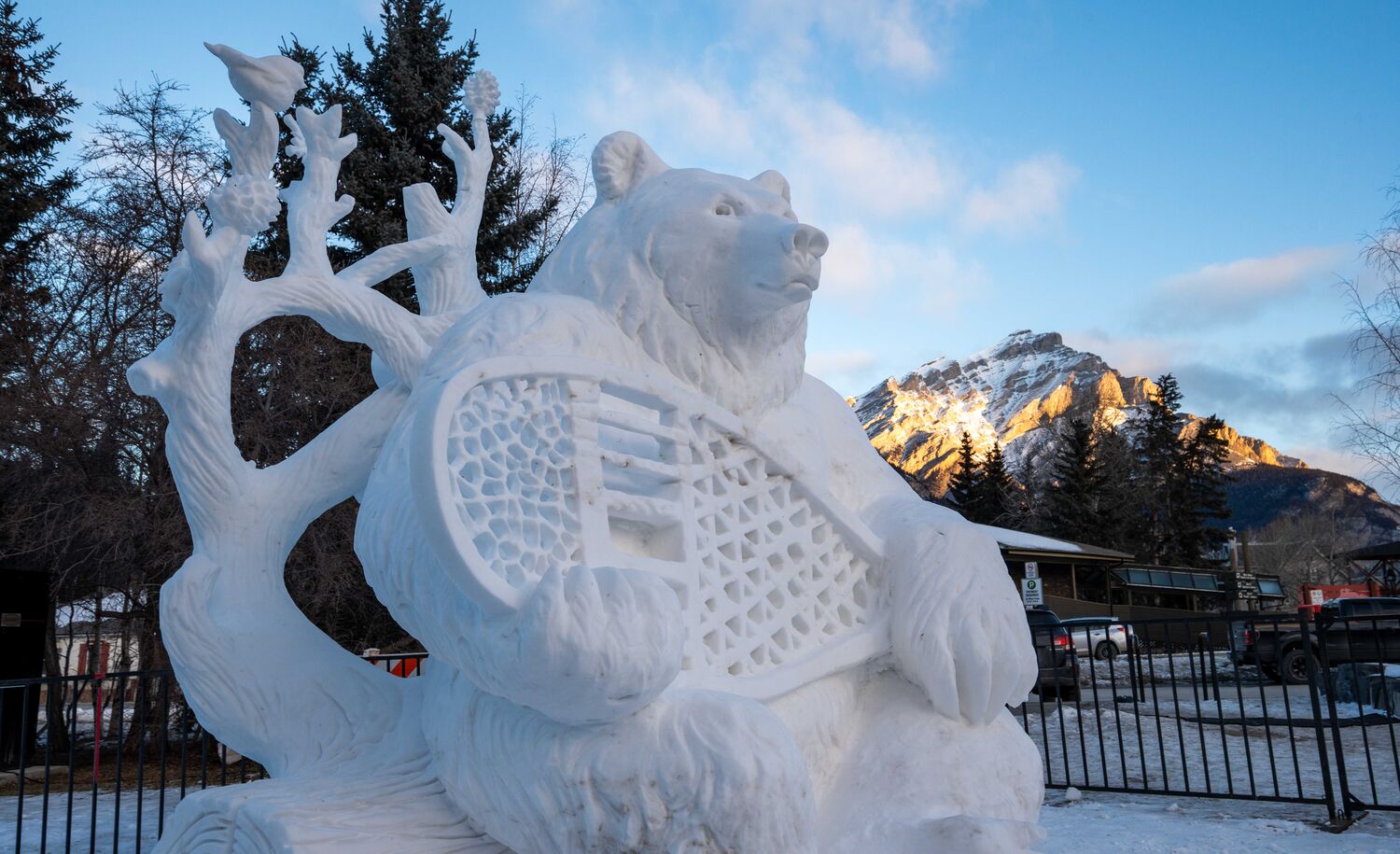A snow sculpture of a bear with a snowshoe at the SnowDays Festival in Banff National Park