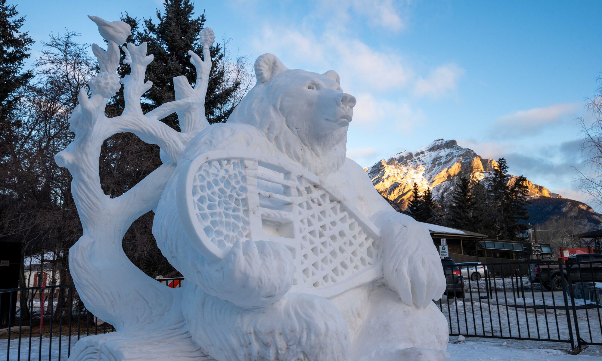 A snow sculpture of a bear with a snowshoe at the SnowDays Festival in Banff National Park
