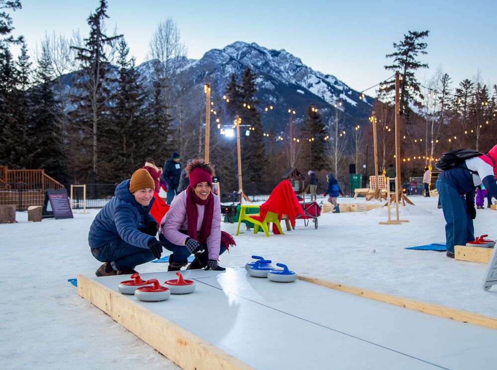 A couple playing a game outside in winter in Banff National Park as apart of the SnowDays Festival