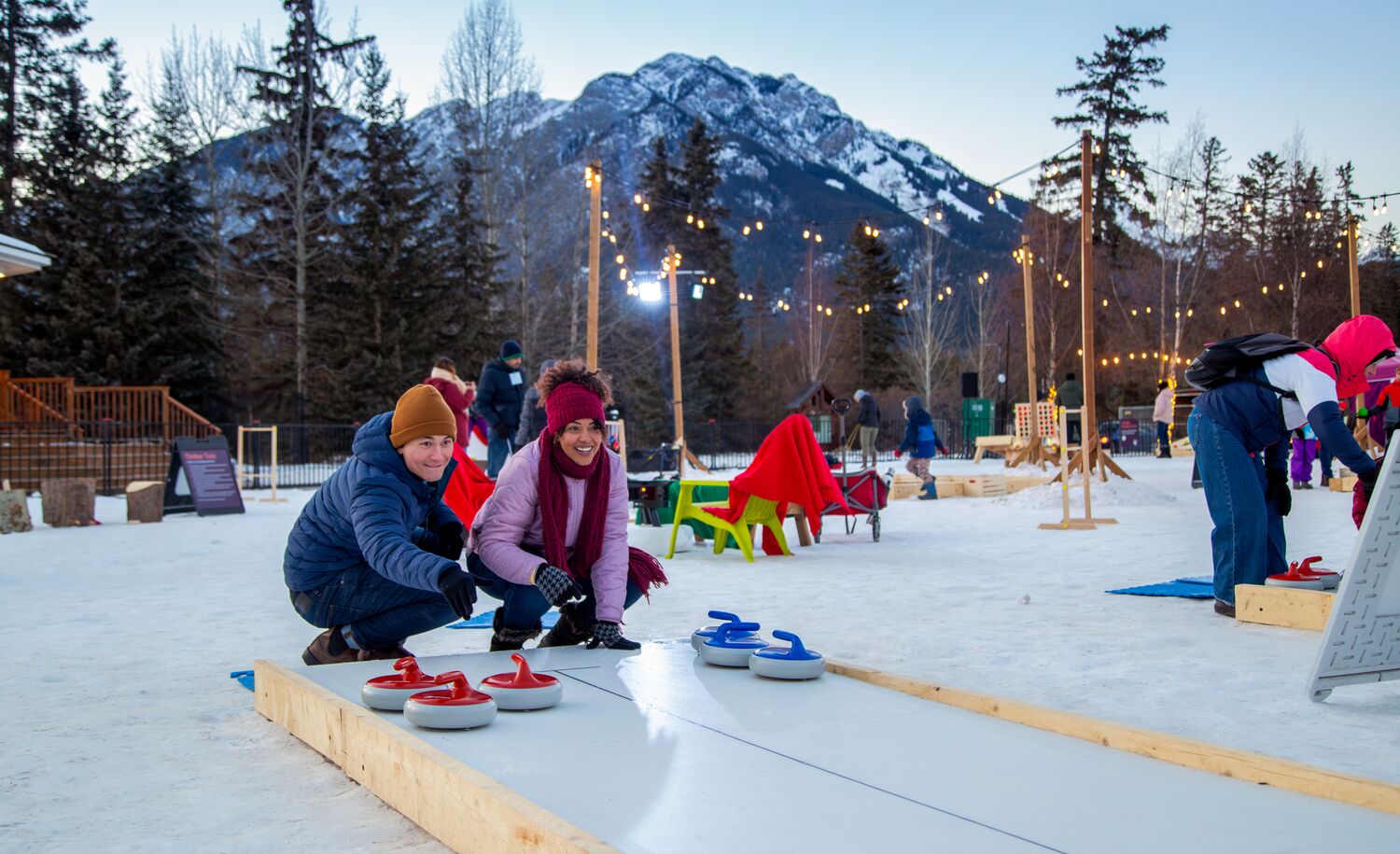 A couple playing a game outside in winter in Banff National Park as apart of the SnowDays Festival