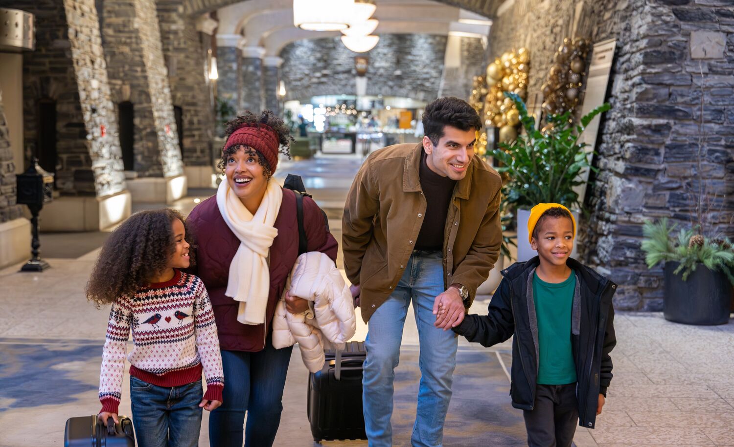 A family of four checking into the Fairmont Banff Springs at Christmas in Banff National Park