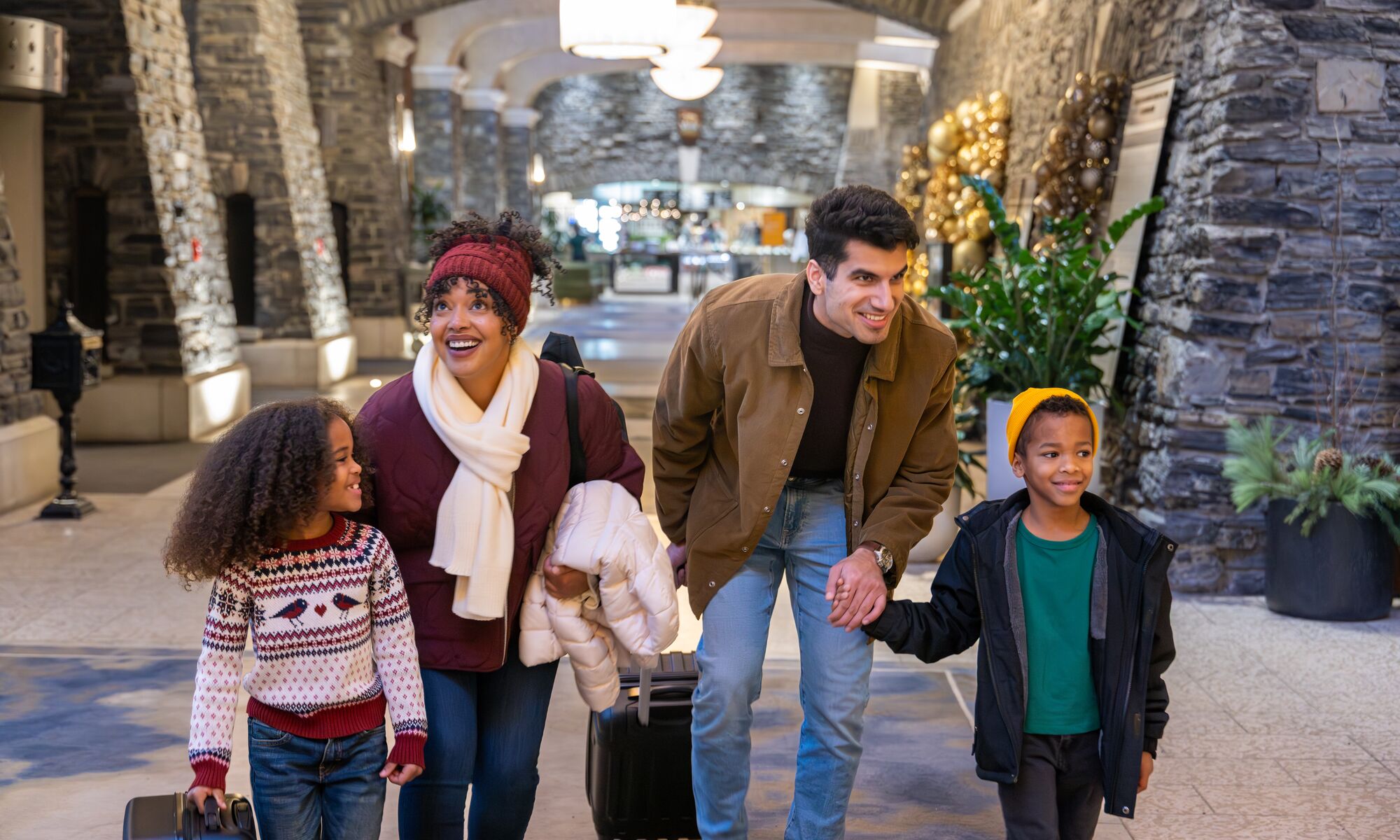 A family of four checking into the Fairmont Banff Springs at Christmas in Banff National Park
