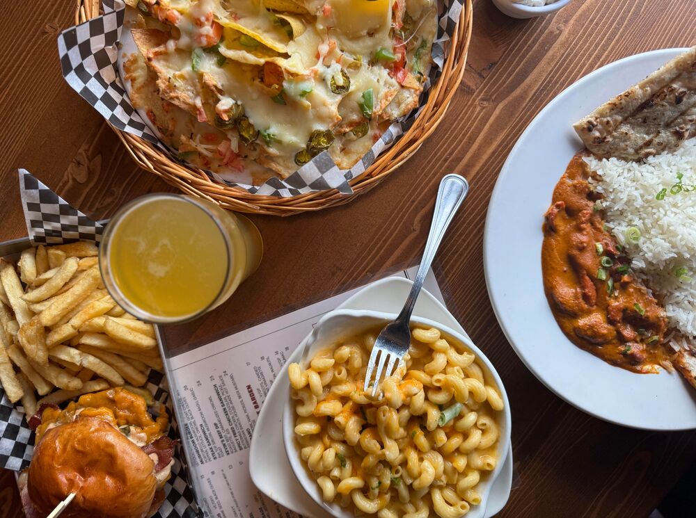 A table with four different plates of food from the Rose and Crown in Banff National Park