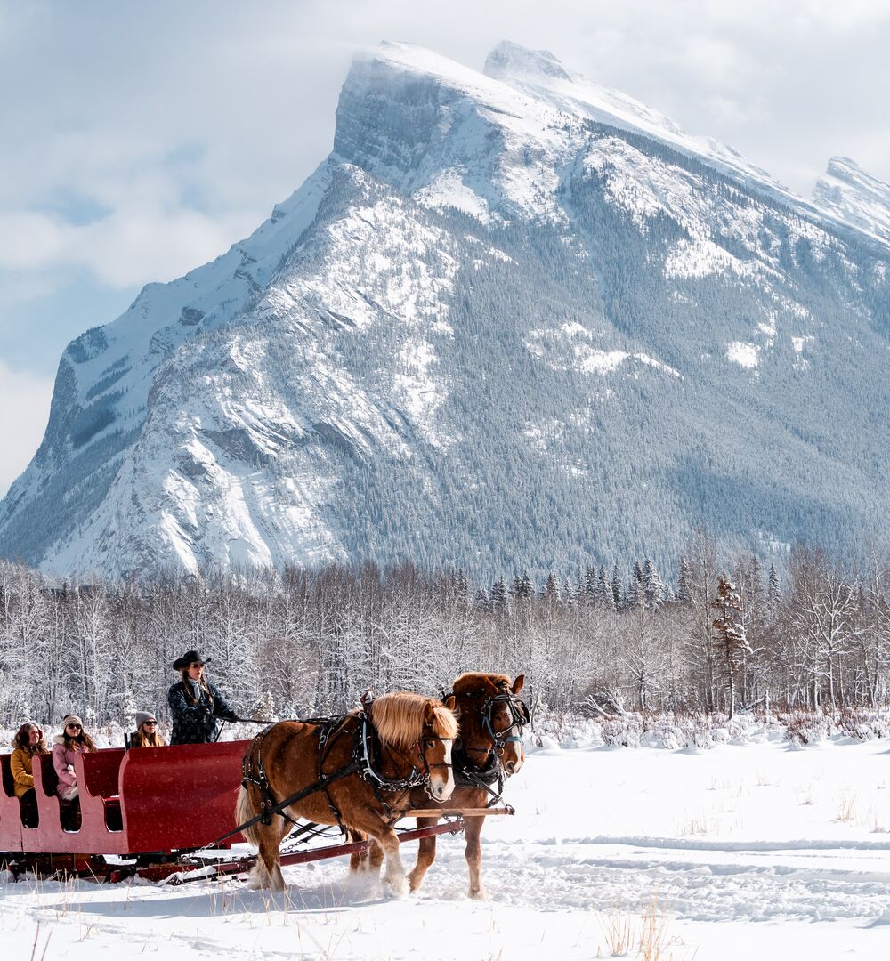 Three people on a sleigh ride in Banff National Park