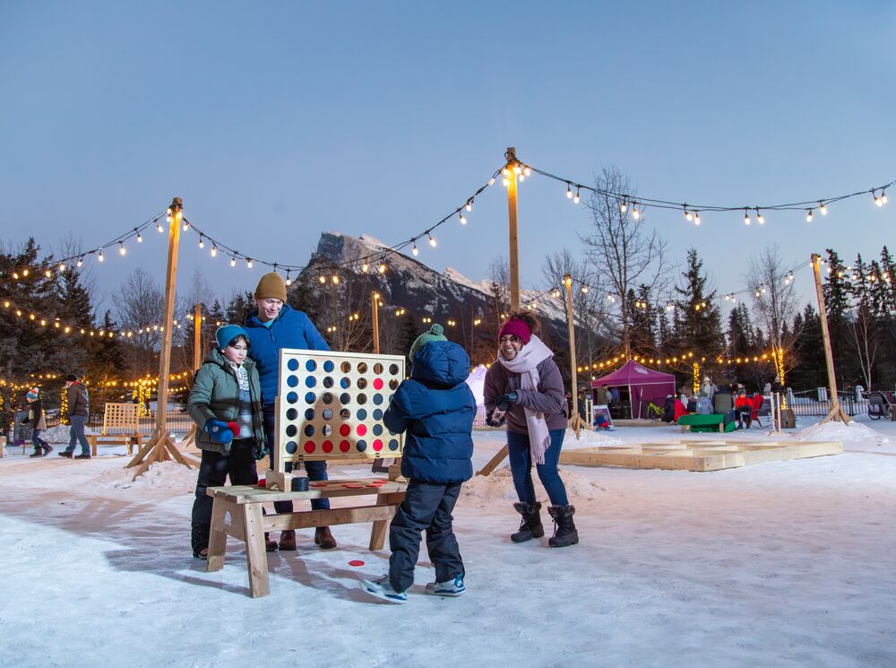 A family playing a game at the Play Zone during SnowDays in Banff National Park