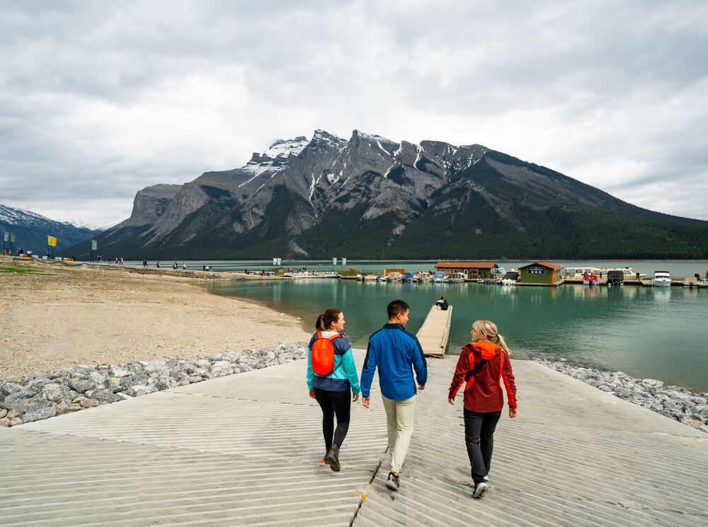 A group of friends walking down to Lake Minnewanka in Banff National Park