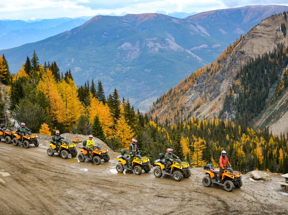 A group of people on a ATV tour in fall in the Canadian Rocky Mountains