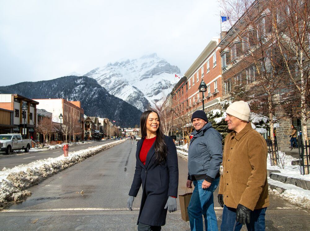 Three people crossing the street in downtown Banff in Banff National Park
