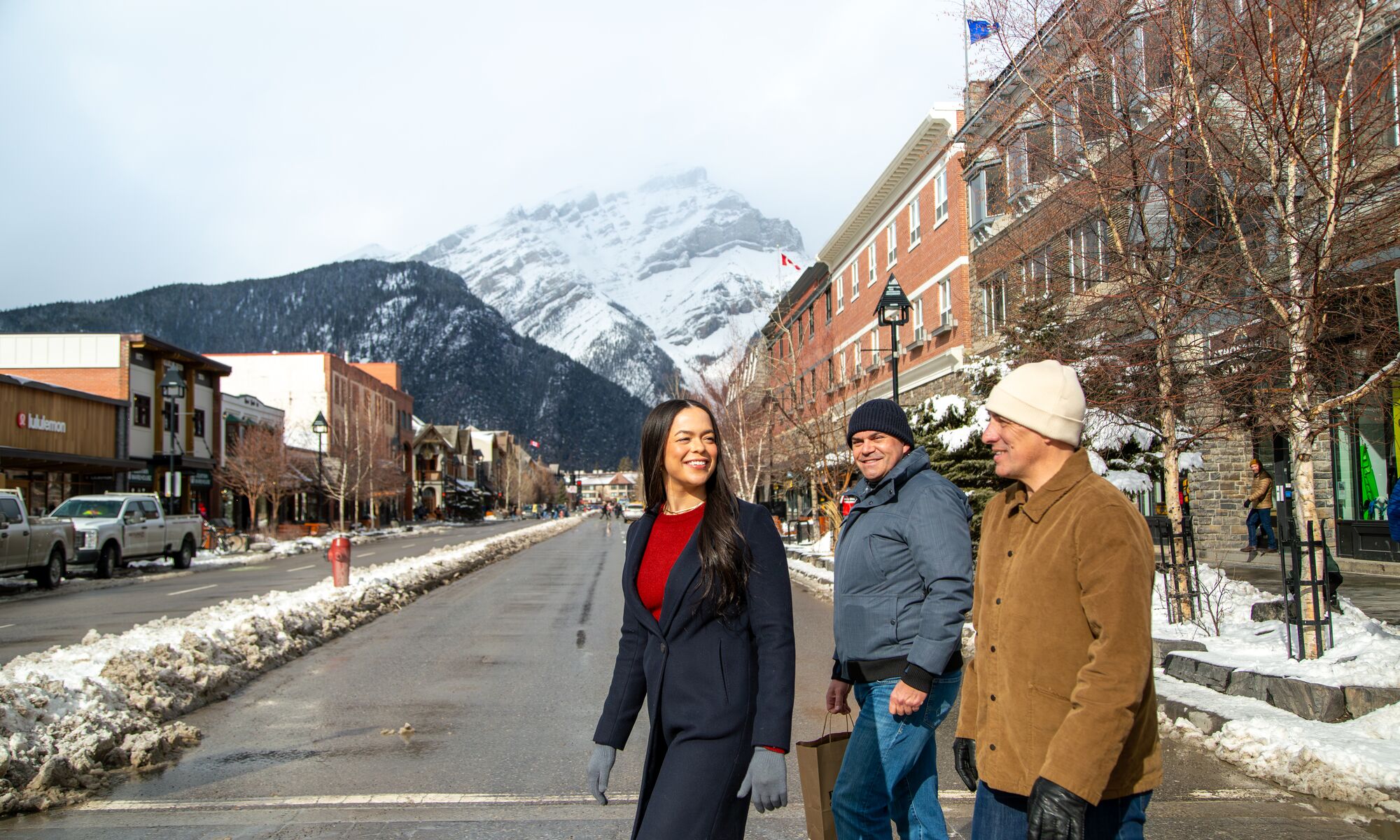 Three people crossing the street in downtown Banff in Banff National Park