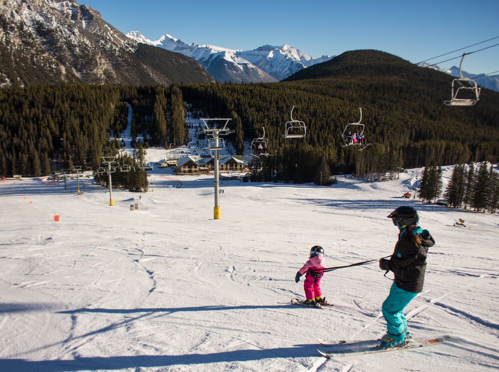 A parent and child learning to ski at Mount Norquay in Banff National Park
