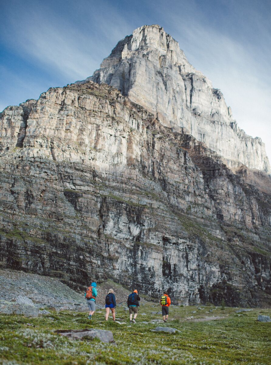 A group of people hiking in Larch Valley below Eifel Peak at Moraine Lake in Banff National Park.