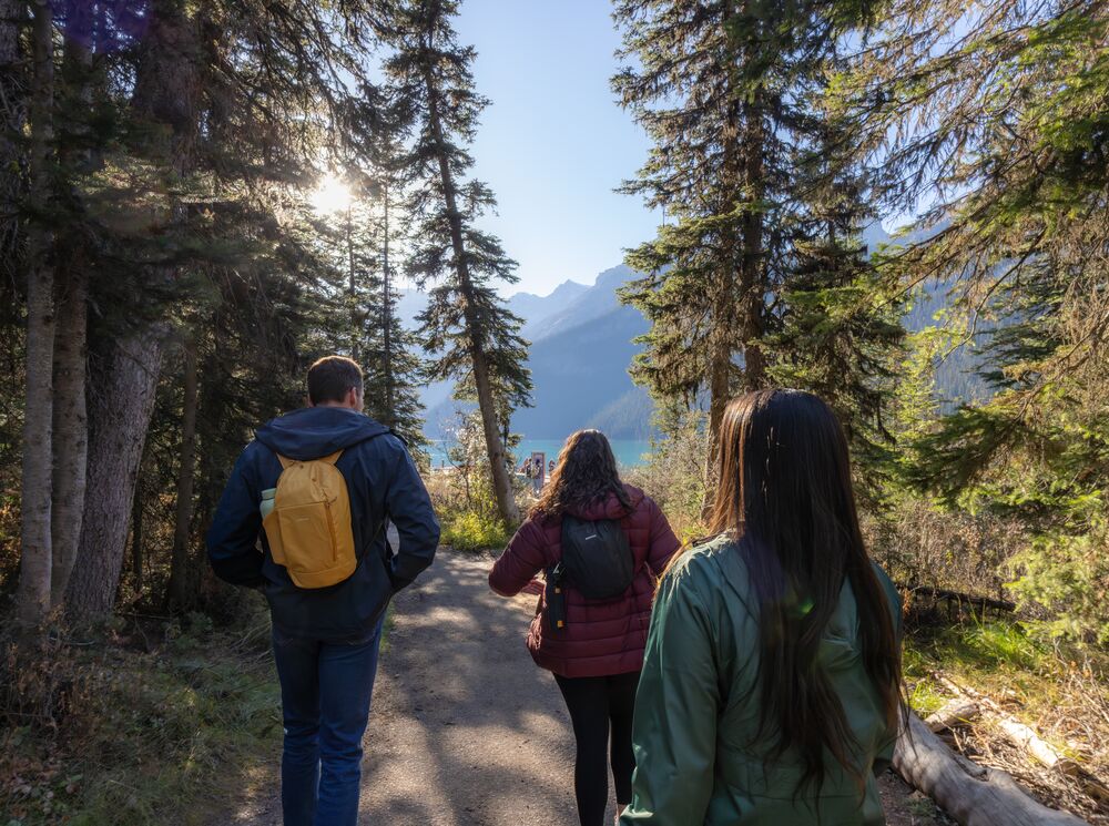 Three people hiking at Lake Louise in Banff National Park
