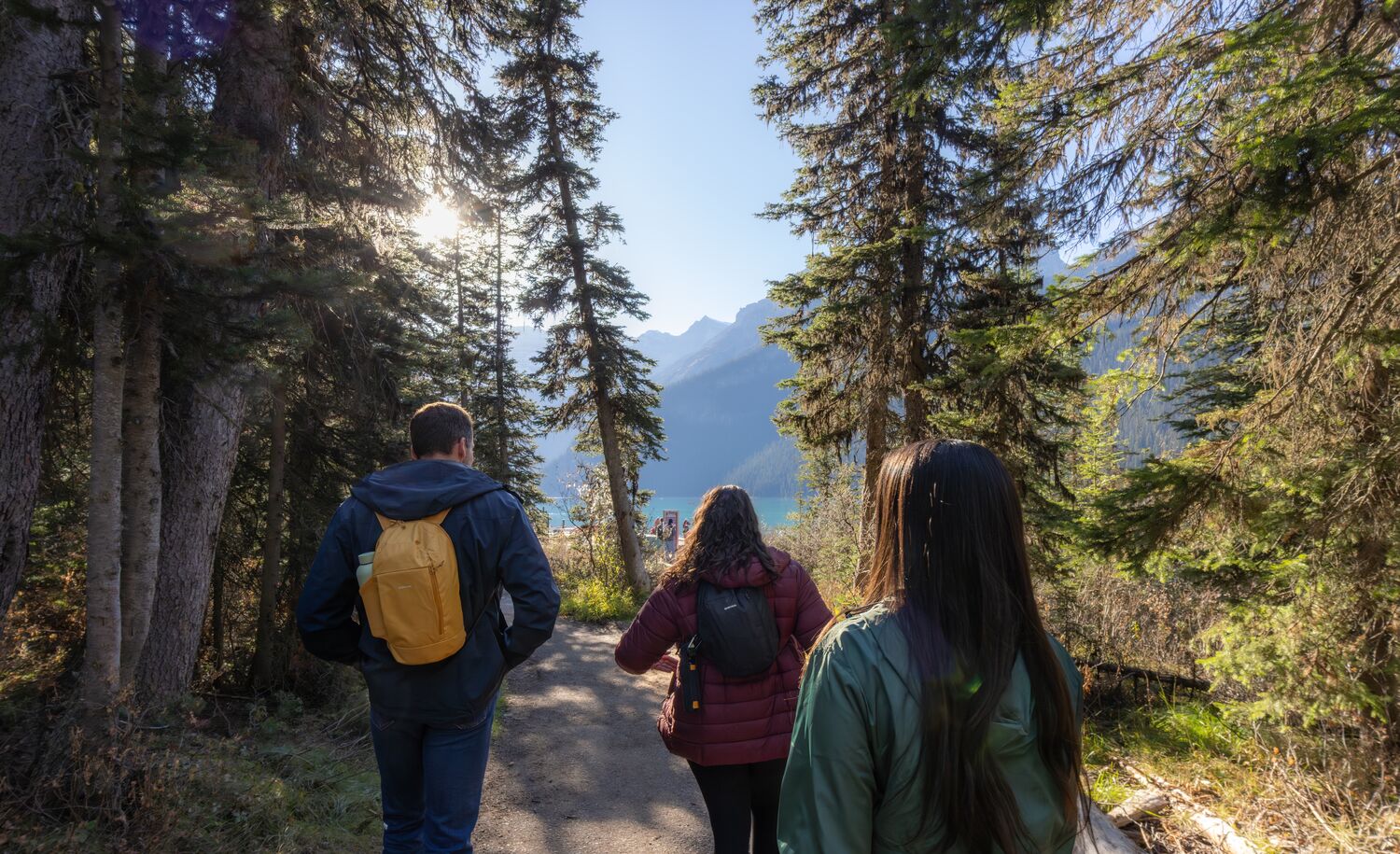 Three people hiking at Lake Louise in Banff National Park