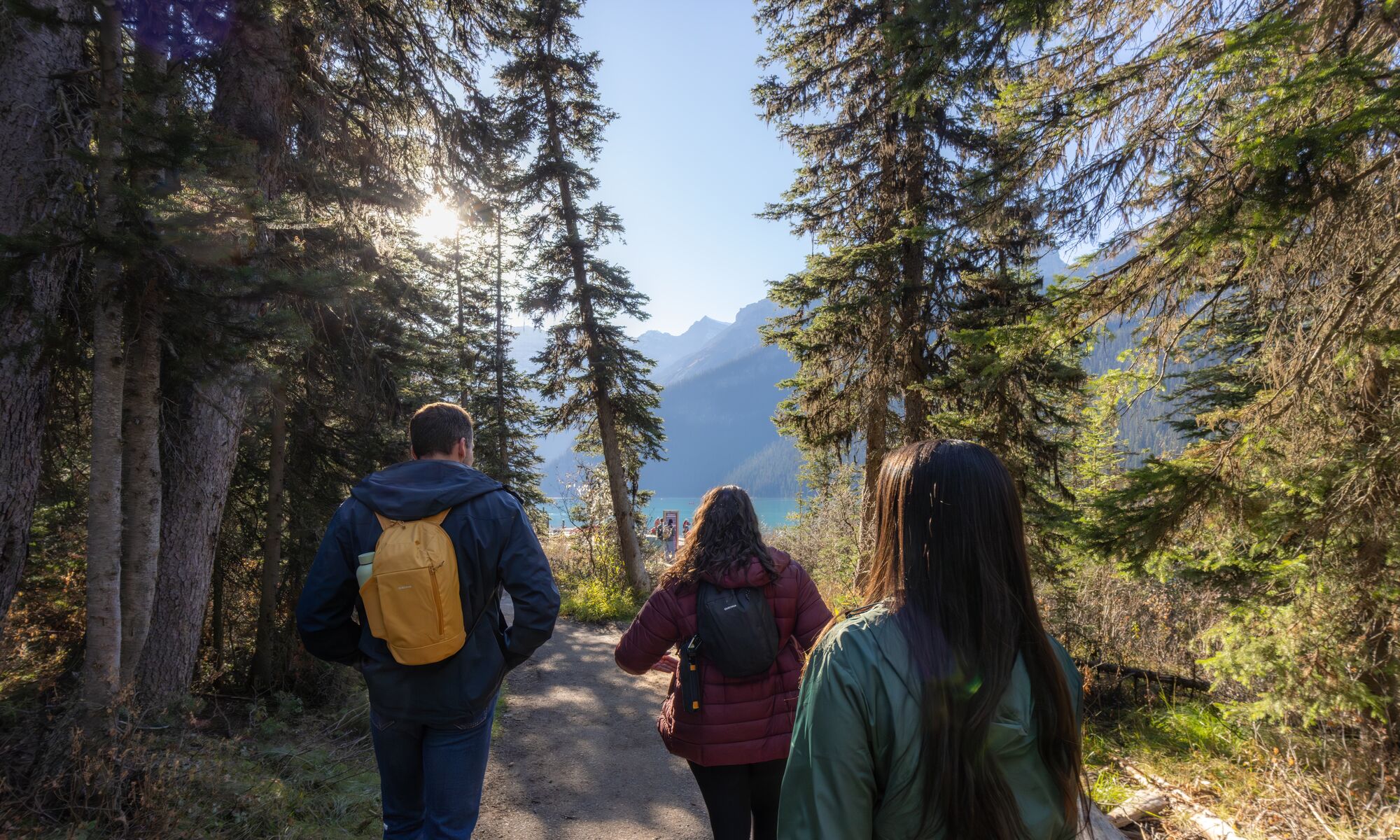 Three people hiking at Lake Louise in Banff National Park