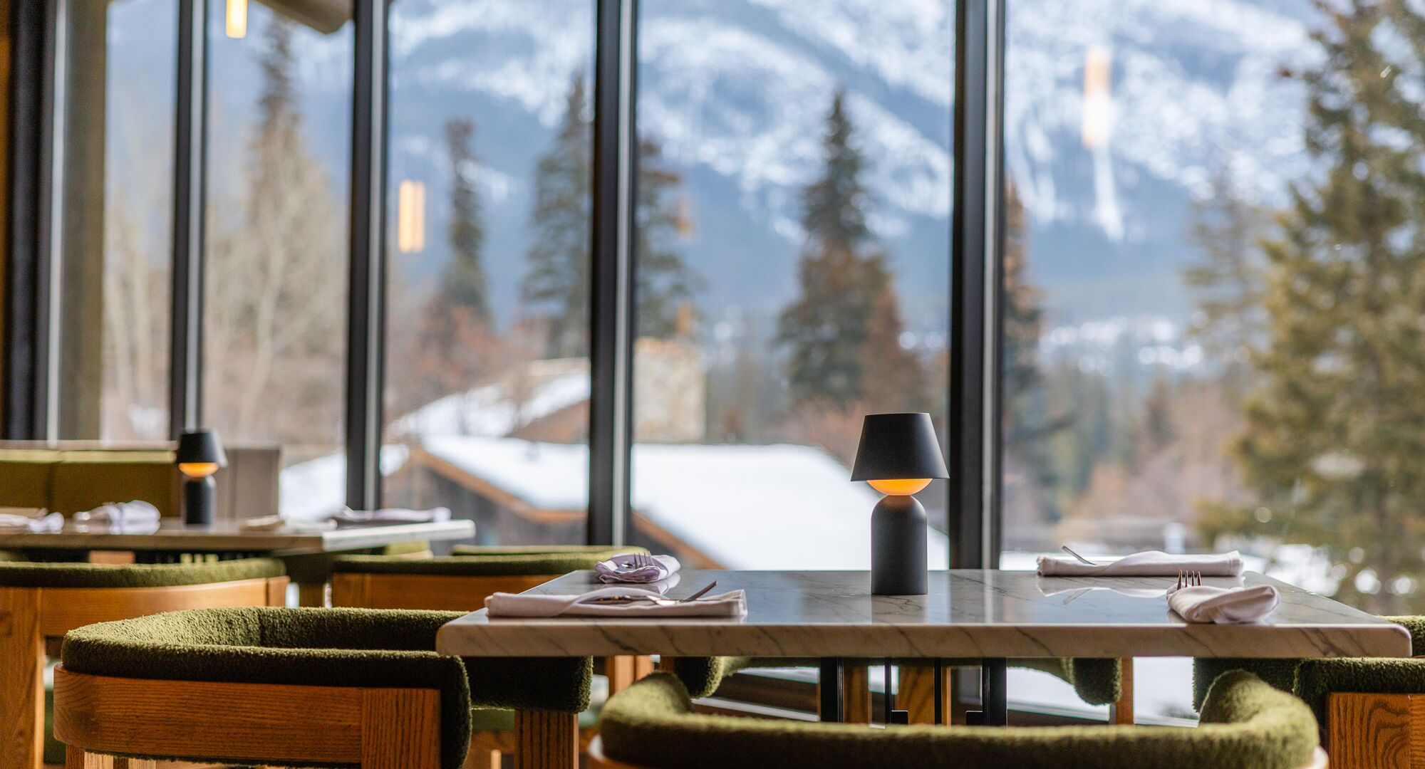 Crave at Banff Park Lodge table by the window with mountain views