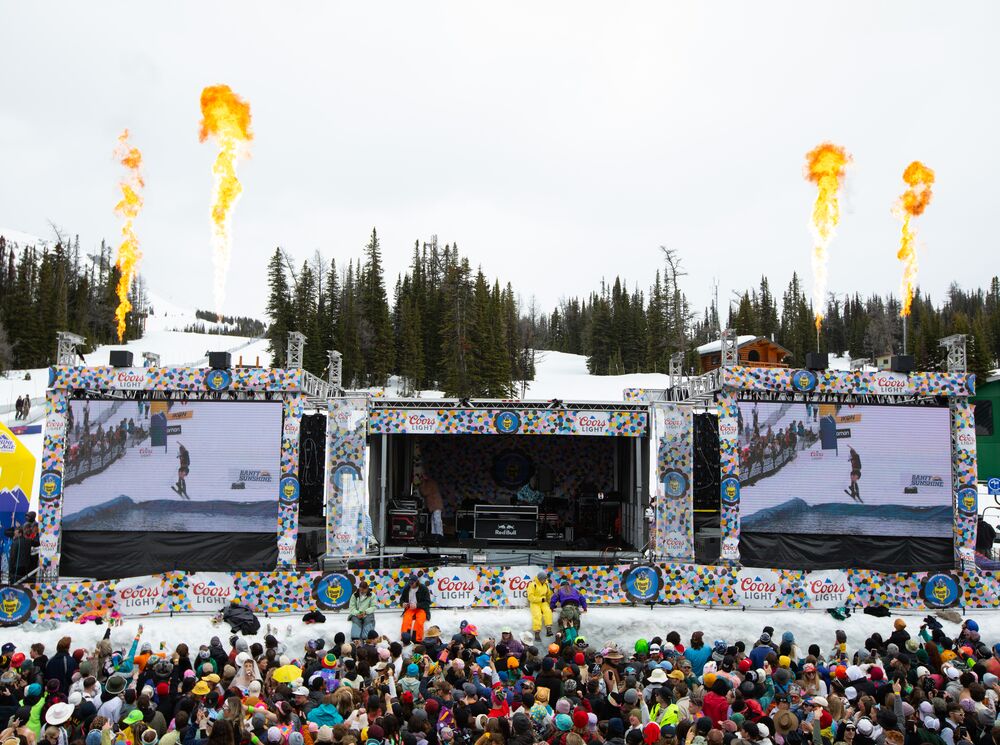 A stage at Sunshine Village for slush cup with lots of people in Banff National Park