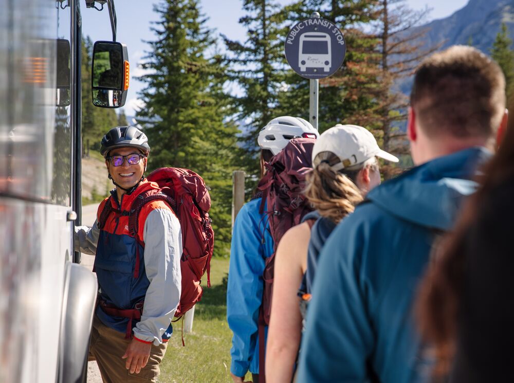 People lining up and getting on a bus in Banff National Park