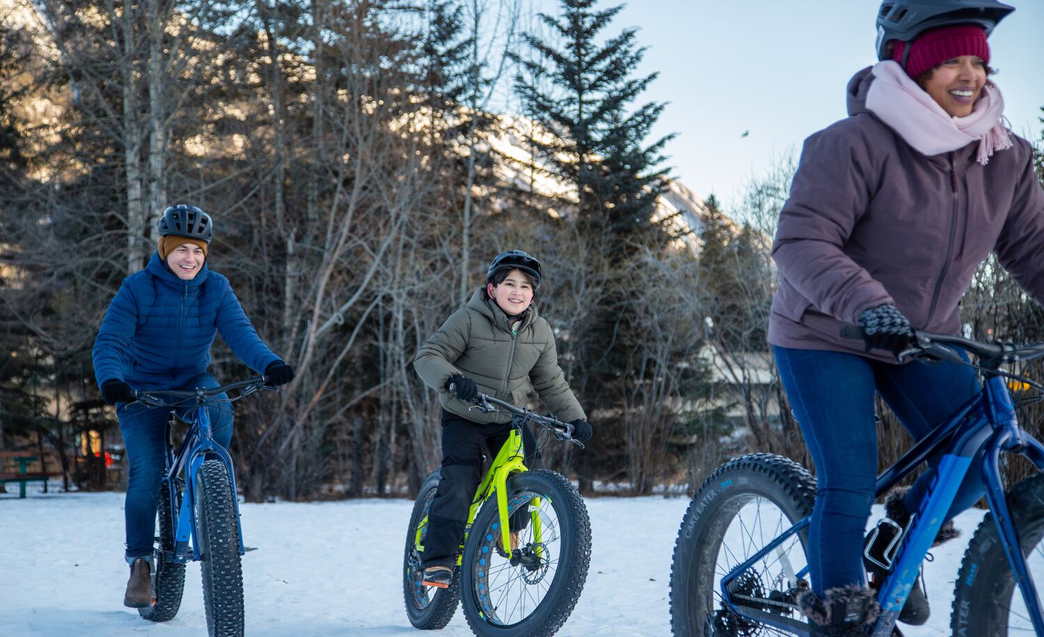 A mom and two children fat biking in Banff National Park