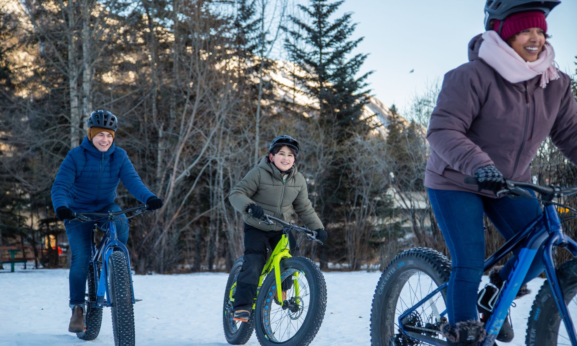 A mom and two children fat biking in Banff National Park