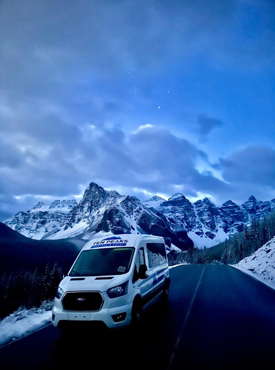 A shuttle bus driving from Moraine Lake in Banff National Park 