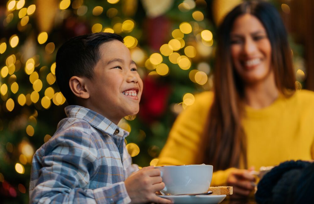 A child enjoying a big hot chocolate for the Hot Chocolate Trail in Banff and Lake Louise.