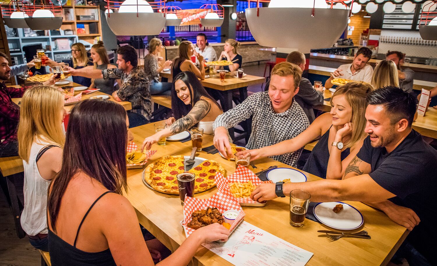 A group of friends eating pizza at a restaurant in Banff National Park