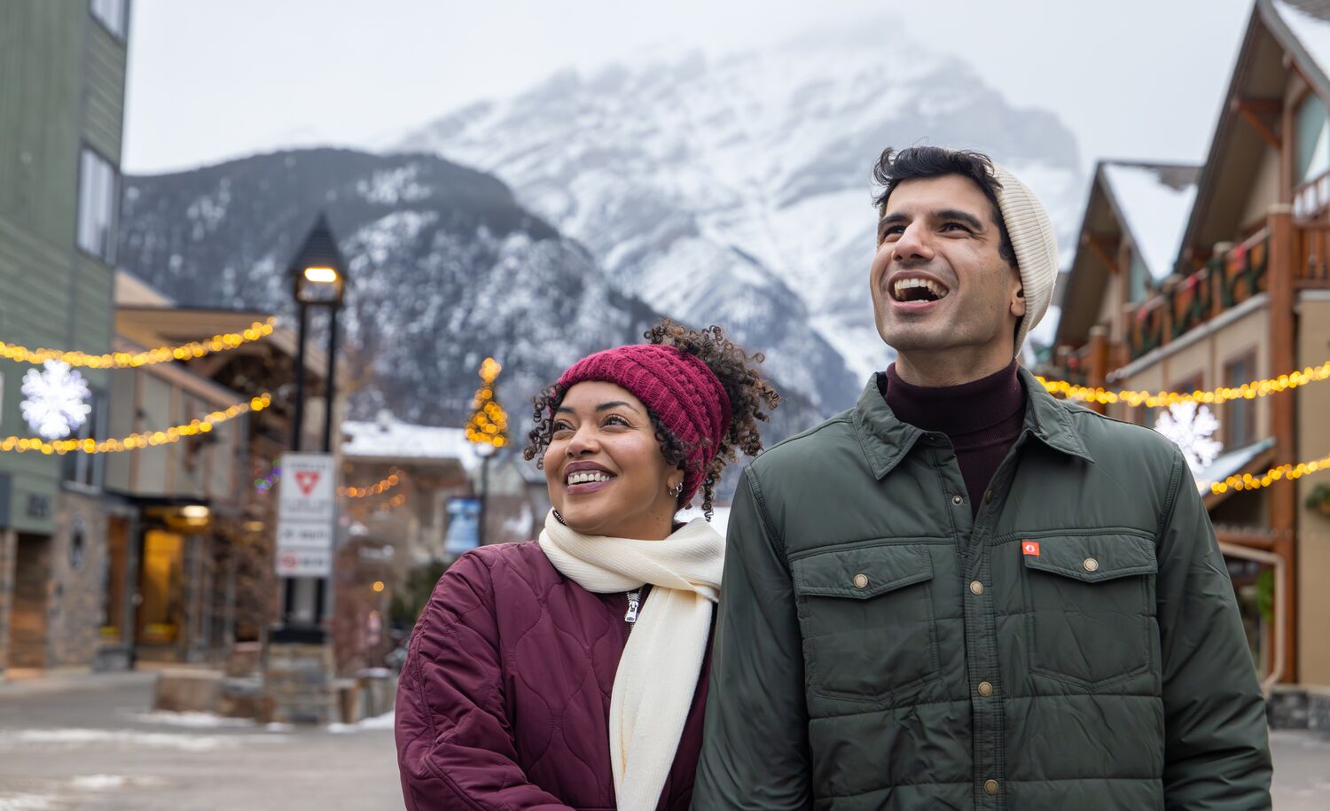 A couple walking down the street in winter in Banff National Park