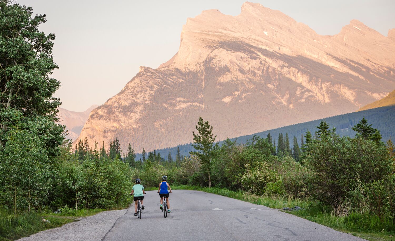Two people biking on Vermillion Lakes road in Banff National Park