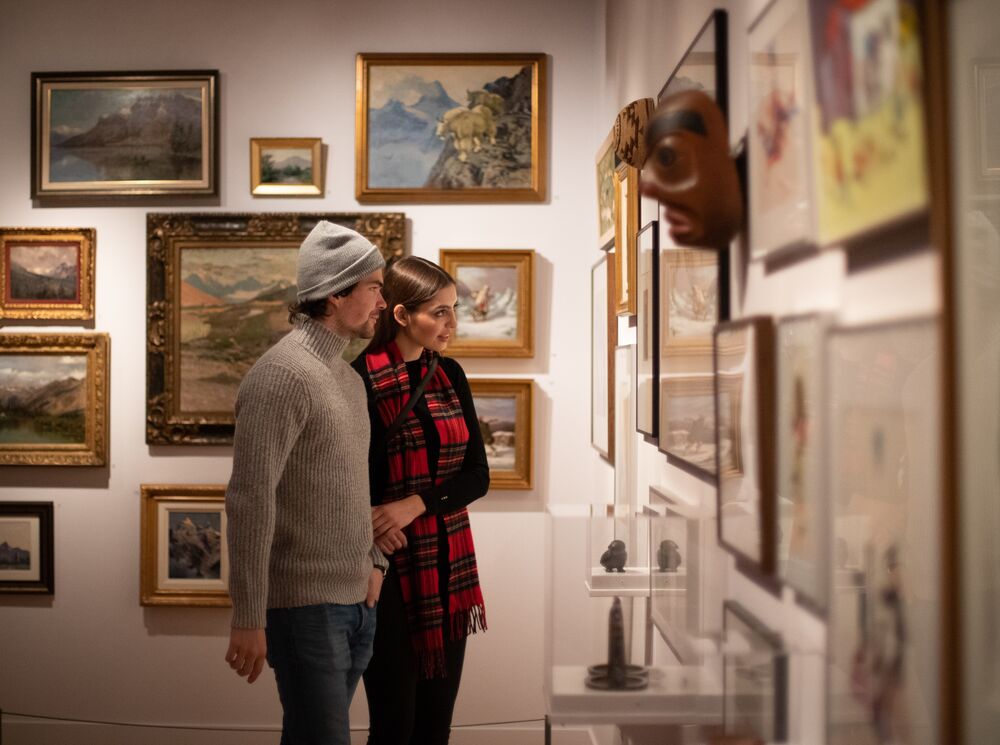 A couple in a museum looking at art in Banff National Park
