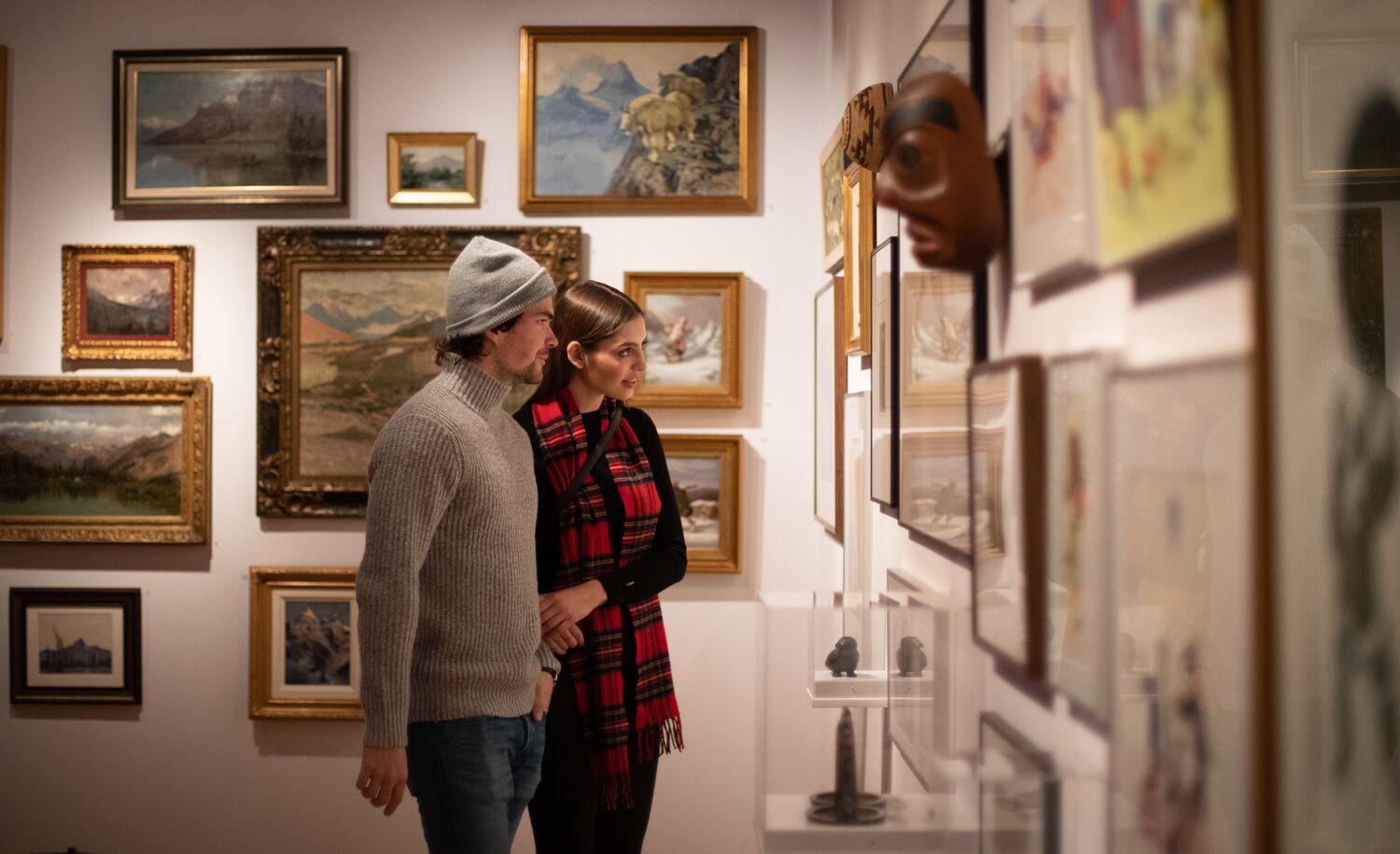 A couple in a museum looking at art in Banff National Park