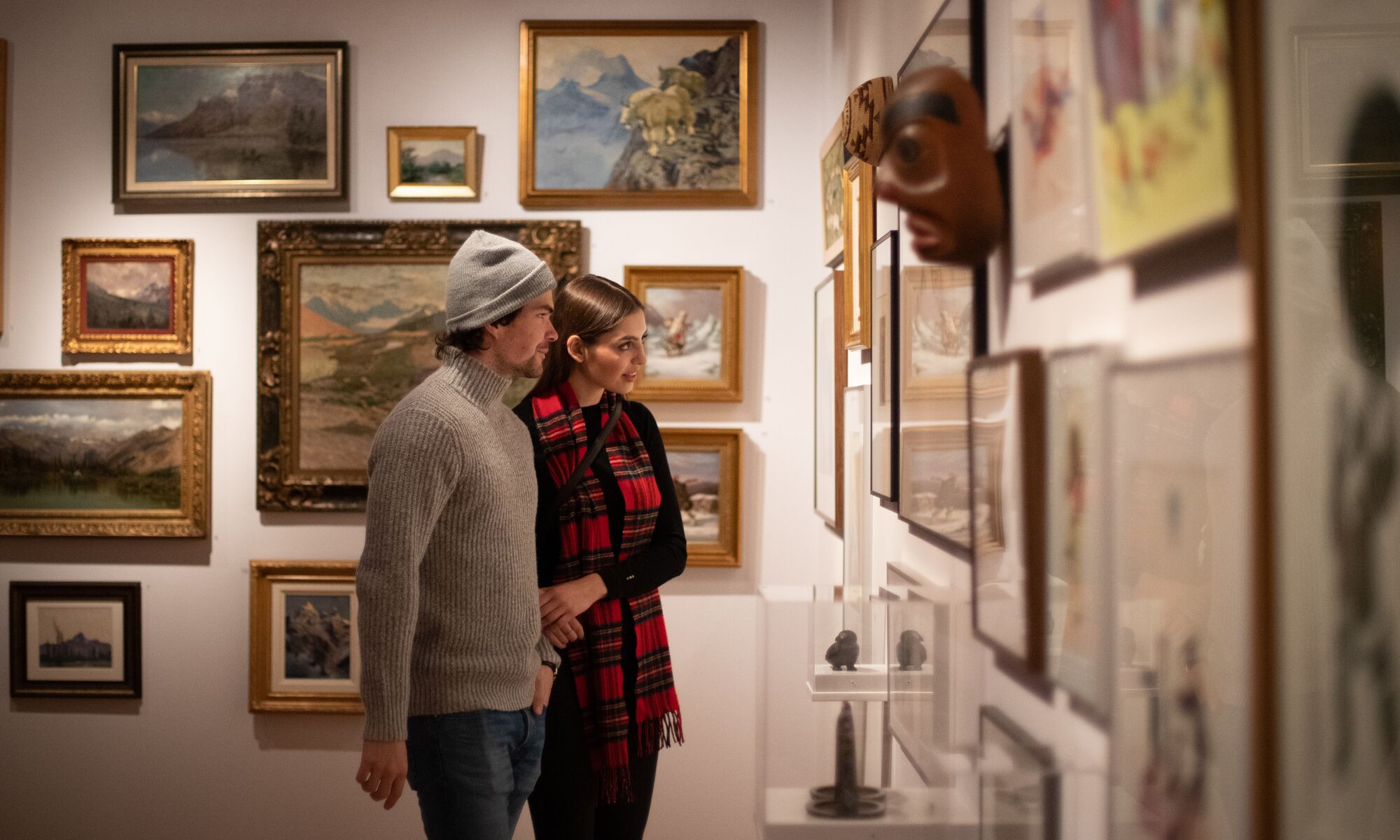 A couple in a museum looking at art in Banff National Park