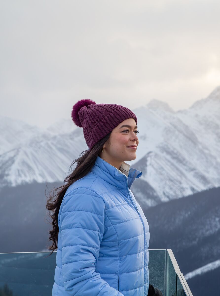 A women stands at the viewing balcony of the Banff Gondola near the Banff Upper Hot Springs.