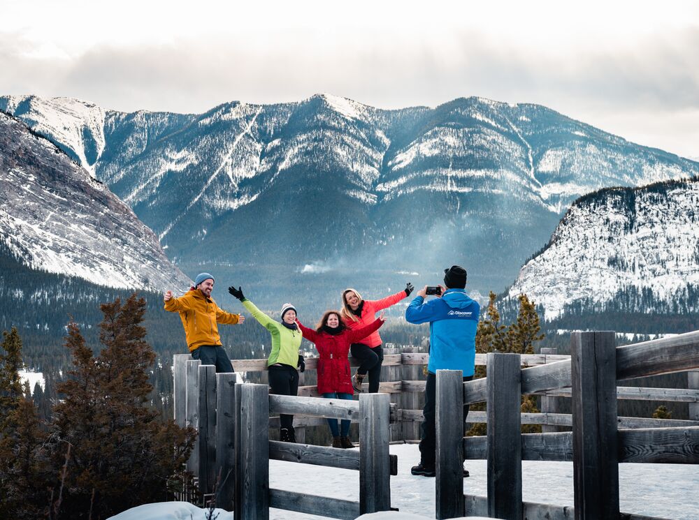 Four people at a viewpoint in Banff National Park in winter
