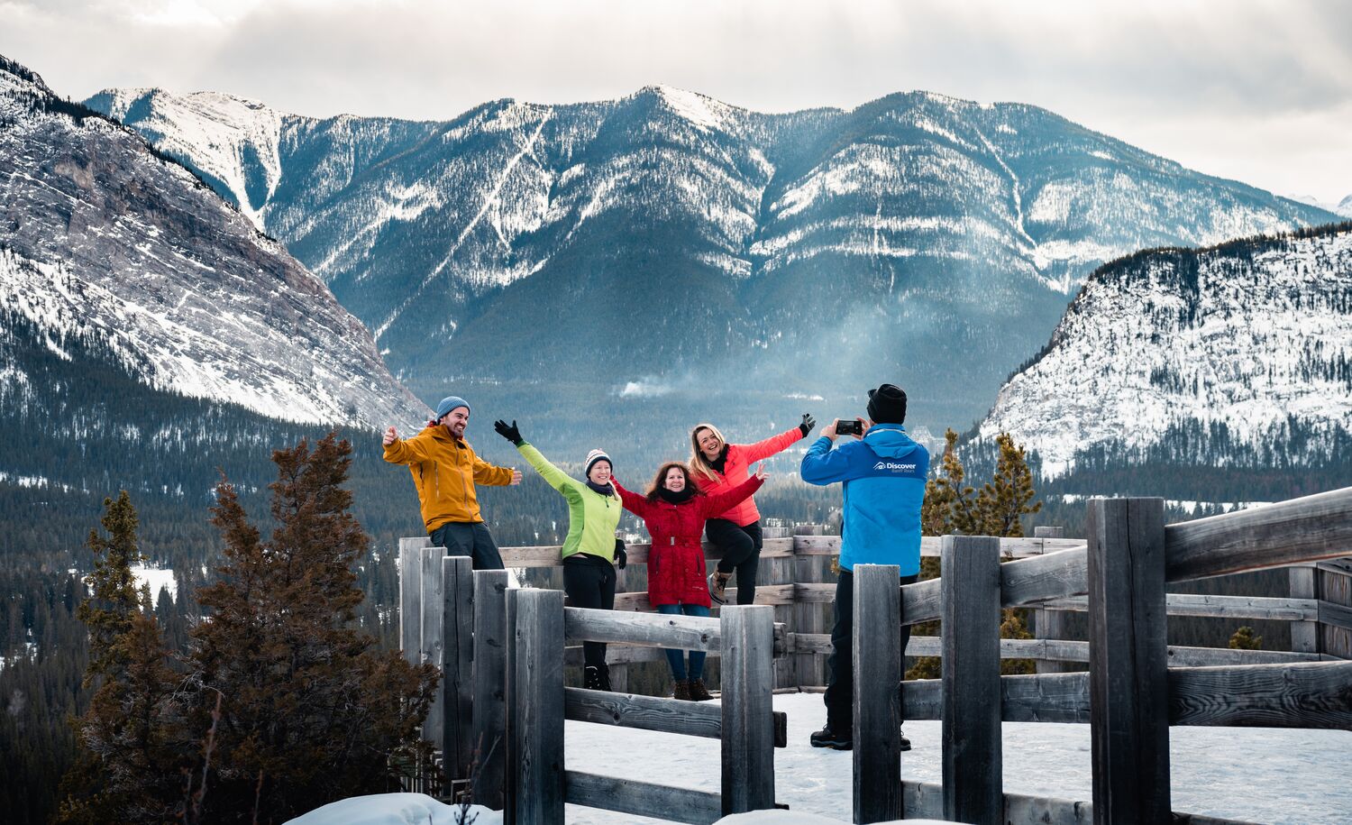 Four people at a viewpoint in Banff National Park in winter