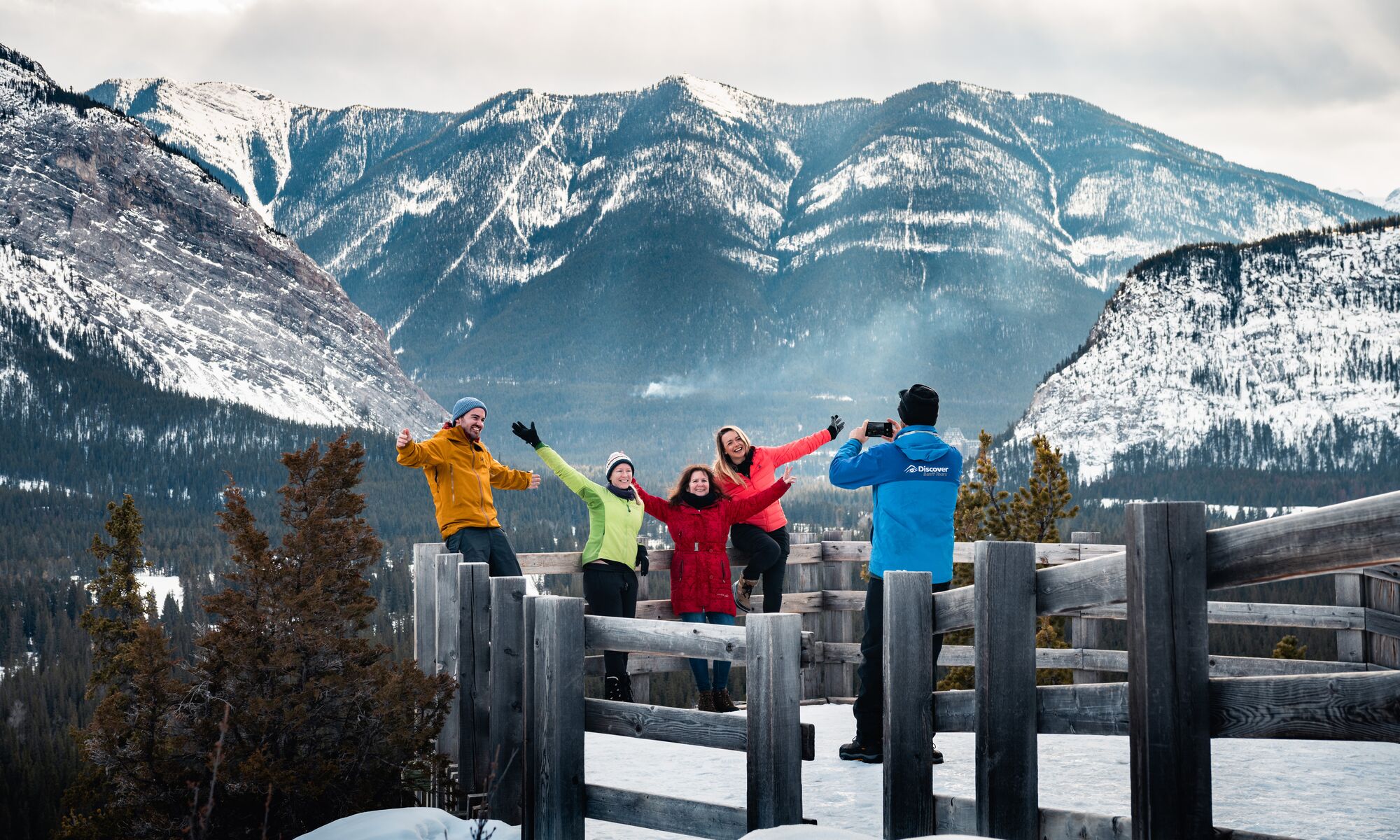 Four people at a viewpoint in Banff National Park in winter