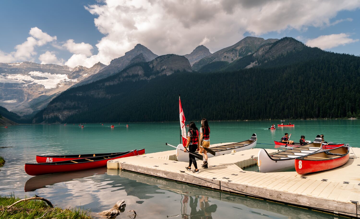 Two people on the Lake Louise canoe docks in Banff National Park
