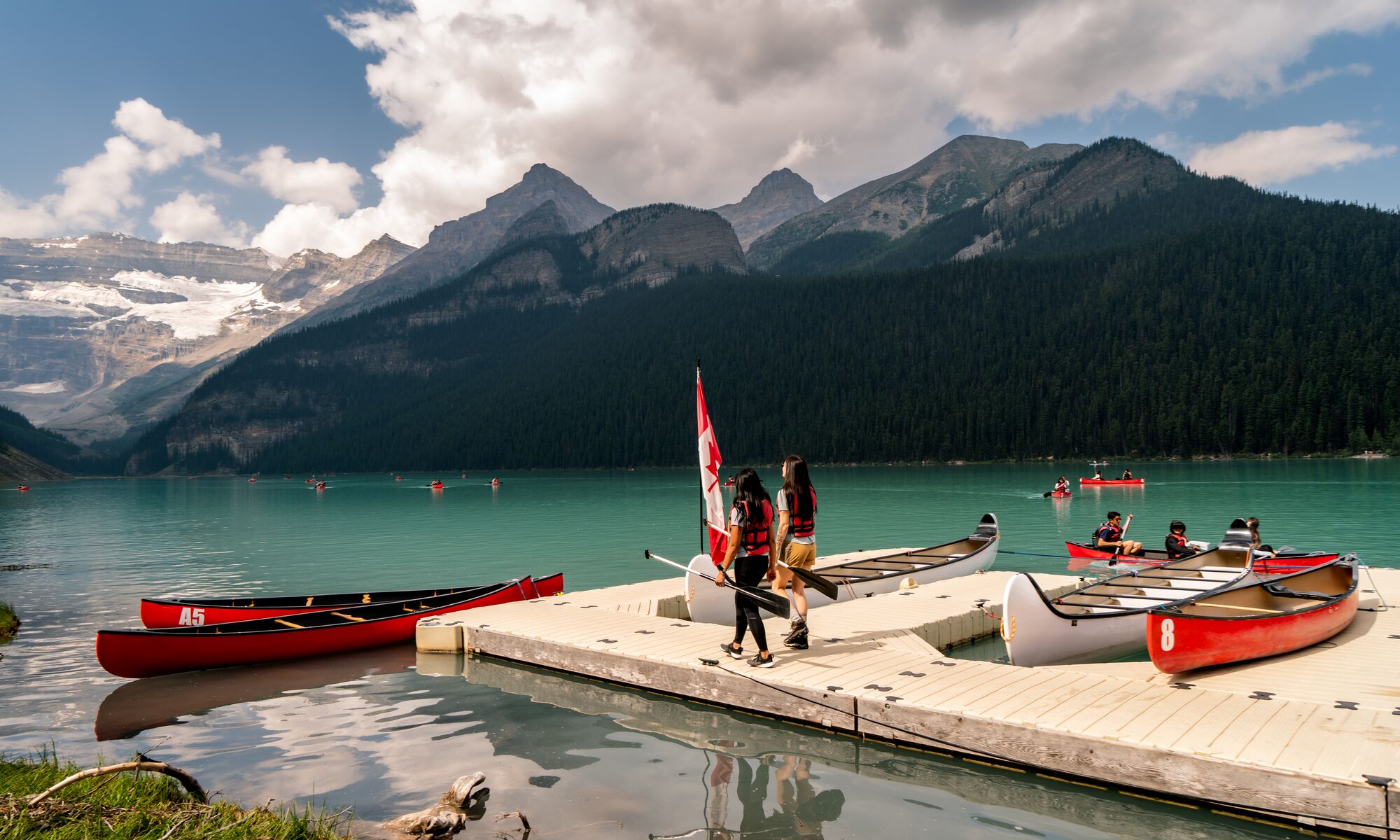 Two people on the Lake Louise canoe docks in Banff National Park