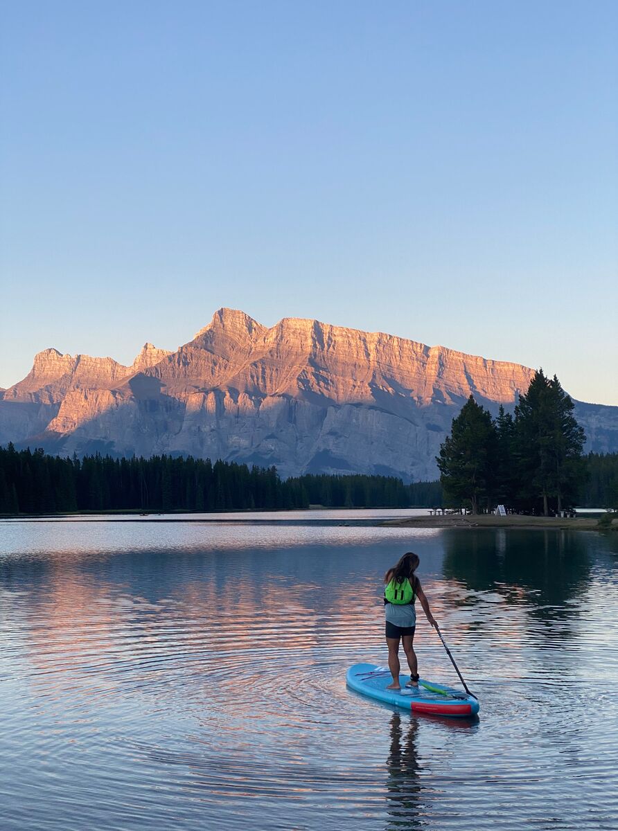 A female paddleboarding on Two Jack Lake in Banff National Park