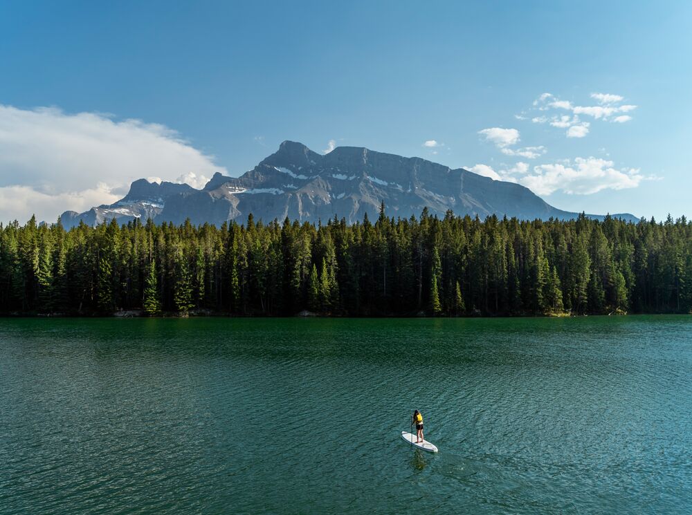 A person paddle boarding on Johnson Lake in Banff National Park