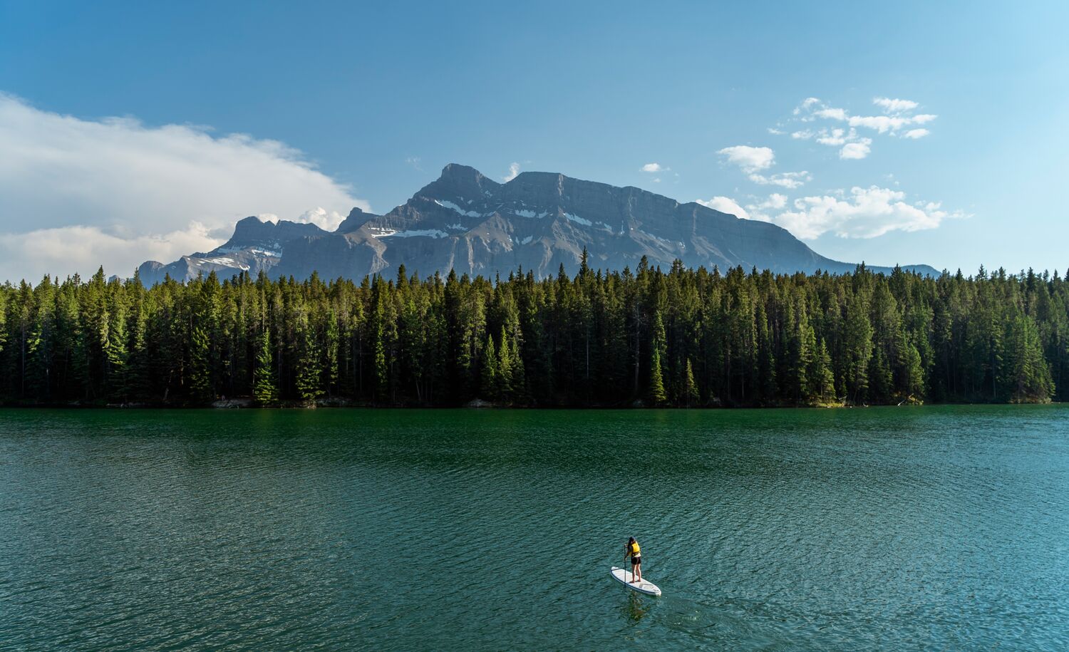 A person paddle boarding on Johnson Lake in Banff National Park