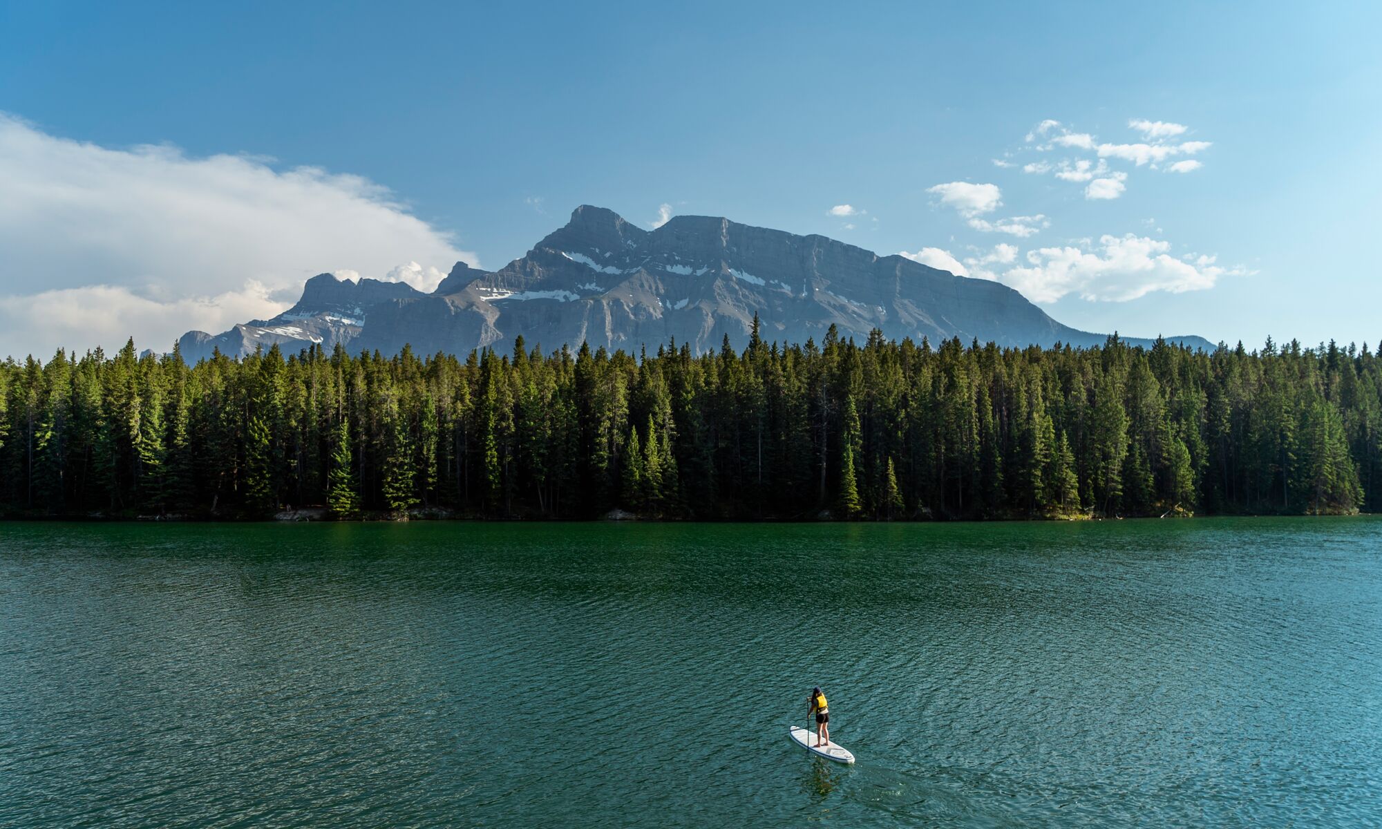 A person paddle boarding on Johnson Lake in Banff National Park