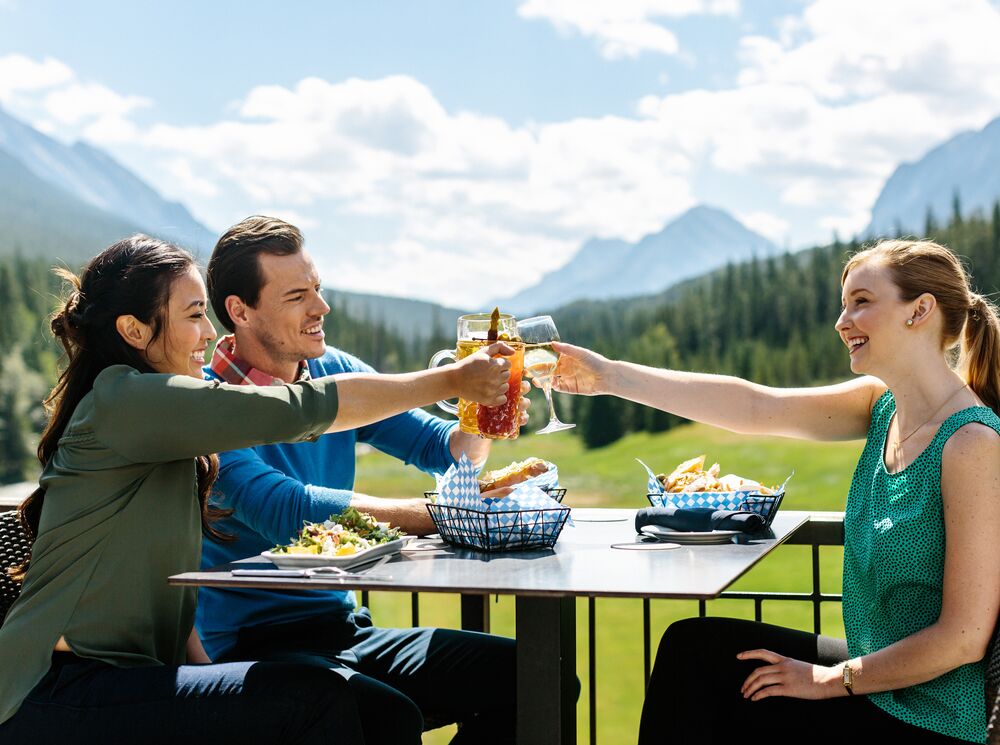 Three people on a patio in Banff National Park