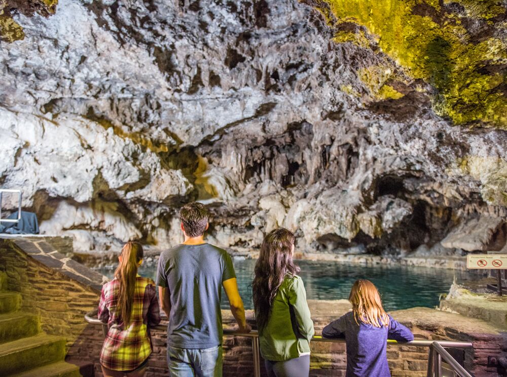Four people inside a cave at the Cave and Basin museum in Banff National Park